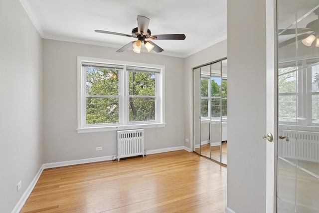 524 Michigan Ave Unit 3N, Evanston, IL 60202 - empty room with radiator heating unit, ceiling fan, plenty of natural light, light wood-type flooring, and crown molding