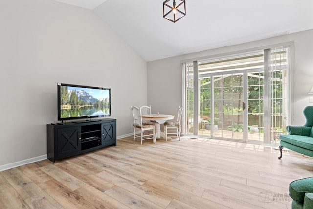 1553 Catalina Ln, Aurora, IL 60504 - living room featuring wood finished floors, plenty of natural light, baseboards, and high vaulted ceiling