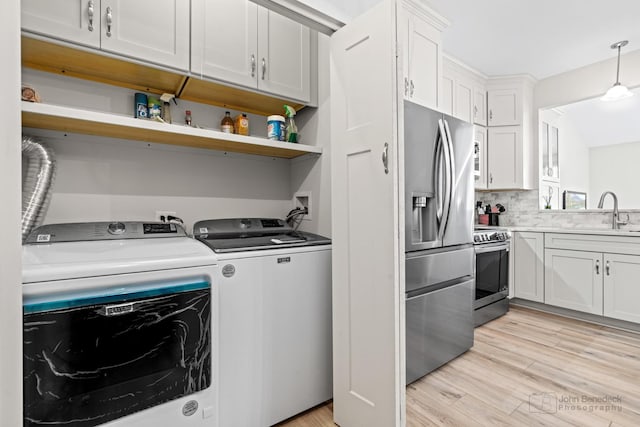 1553 Catalina Ln, Aurora, IL 60504 - washroom featuring washer and clothes dryer and light wood-type flooring