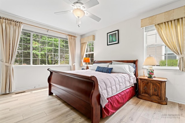 1553 Catalina Ln, Aurora, IL 60504 - bedroom featuring light wood finished floors, a ceiling fan, and baseboards
