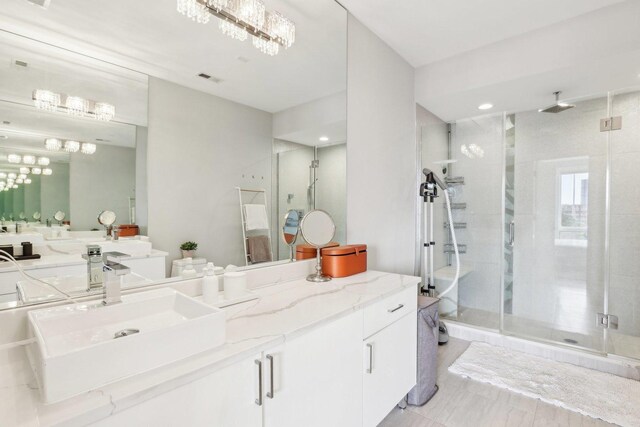650 N Morgan St Unit 303, Chicago, IL 60642 - bathroom featuring a shower stall, vanity, and recessed lighting
