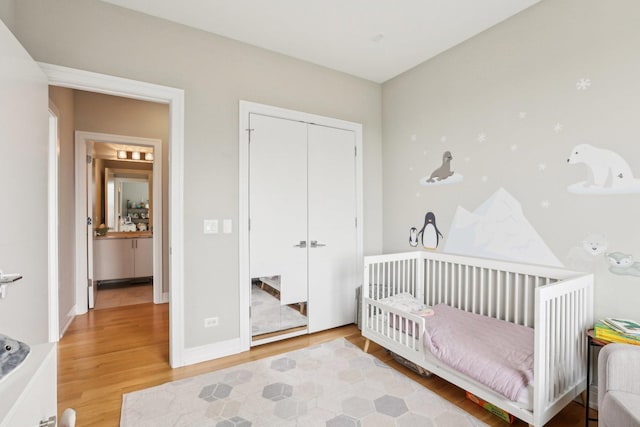 650 N Morgan St Unit 303, Chicago, IL 60642 - bedroom featuring wood finished floors, a closet, a nursery area, and baseboards