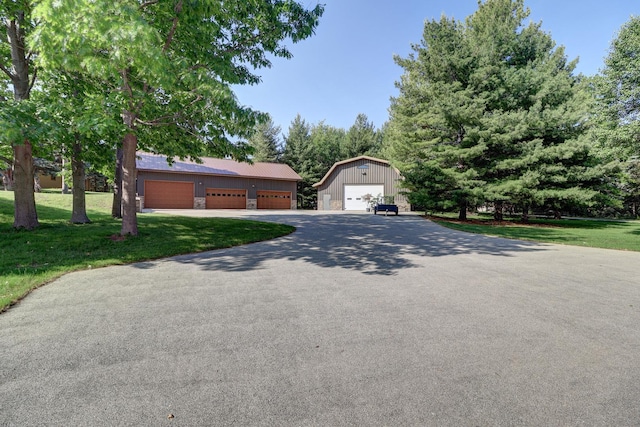 701A Hill Dr, Rock Falls, IL 61071 - view of front of home featuring a front yard, an outbuilding, a garage, and asphalt driveway
