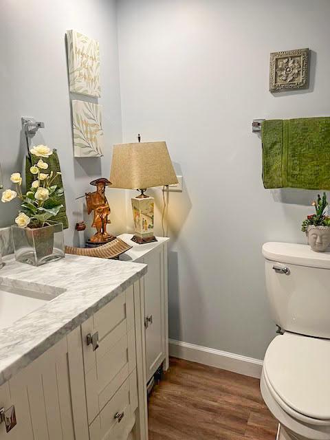 445 N Park Blvd Unit 3D, Glen Ellyn, IL 60137 - bathroom with toilet, vanity, wood finished floors, and baseboards