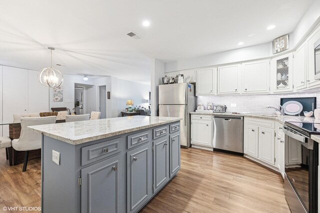 445 N Park Blvd Unit 3D, Glen Ellyn, IL 60137 - kitchen with stainless steel appliances, gray cabinets, white cabinetry, a chandelier, and a kitchen island