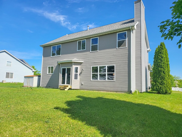 383 Prairie Knoll Dr, Poplar Grove, IL 61065 - back of property with entry steps, a lawn, and a chimney