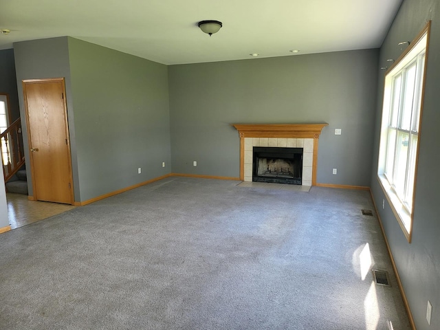 383 Prairie Knoll Dr, Poplar Grove, IL 61065 - unfurnished living room with baseboards, a fireplace, carpet, and stairs