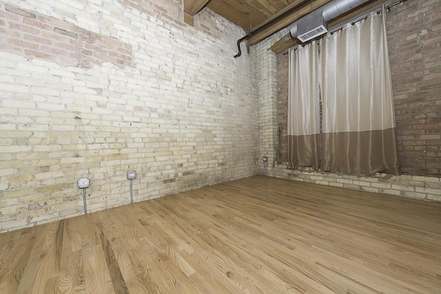 420 S Clinton St Unit 408A, Chicago, IL 60607 - spare room with brick wall and wood finished floors