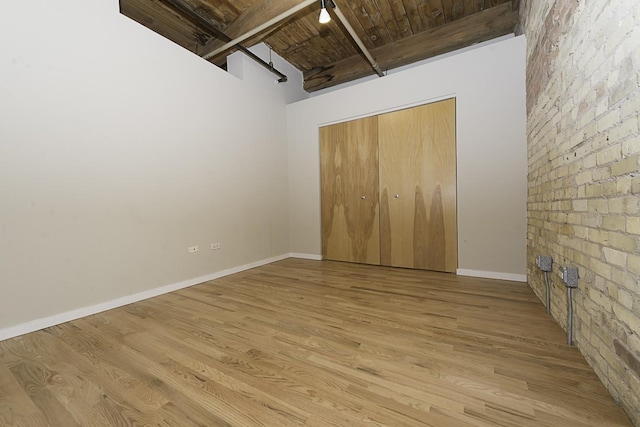 420 S Clinton St Unit 408A, Chicago, IL 60607 - unfurnished bedroom with wooden ceiling with exposed beams, wood finished floors, baseboards, a closet, and a towering ceiling