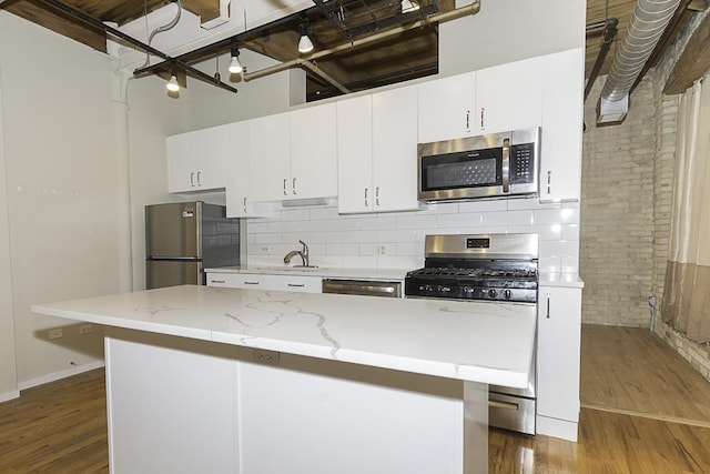 420 S Clinton St Unit 408A, Chicago, IL 60607 - kitchen featuring stainless steel appliances, dark wood-style flooring, a sink, and decorative backsplash