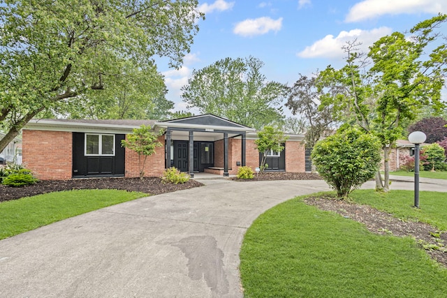 18908 E Louise Dr, Lansing, IL 60438 - view of front of house with a front yard, brick siding, and curved driveway