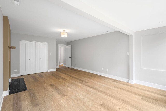 18908 E Louise Dr, Lansing, IL 60438 - unfurnished bedroom with light wood-type flooring, baseboards, and a closet