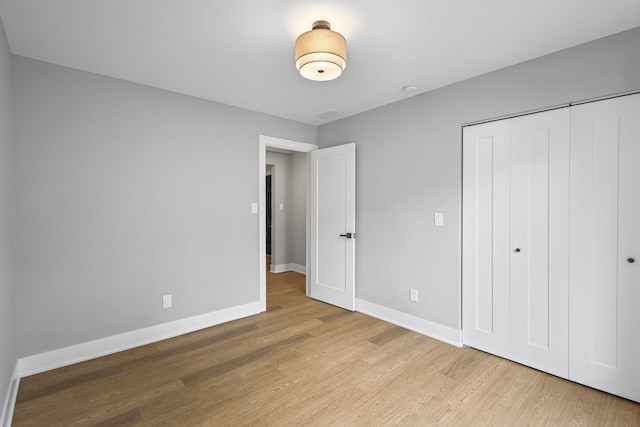 18908 E Louise Dr, Lansing, IL 60438 - unfurnished bedroom featuring wood finished floors, baseboards, and a closet