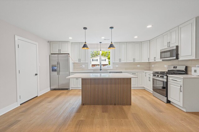 18908 E Louise Dr, Lansing, IL 60438 - kitchen featuring stainless steel appliances, light wood-style floors, light countertops, a sink, and decorative backsplash