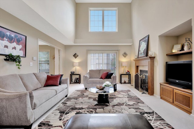 3911 Summer Sage Ct, Champaign, IL 61822 - living area with light colored carpet, healthy amount of natural light, a high ceiling, and a fireplace with flush hearth