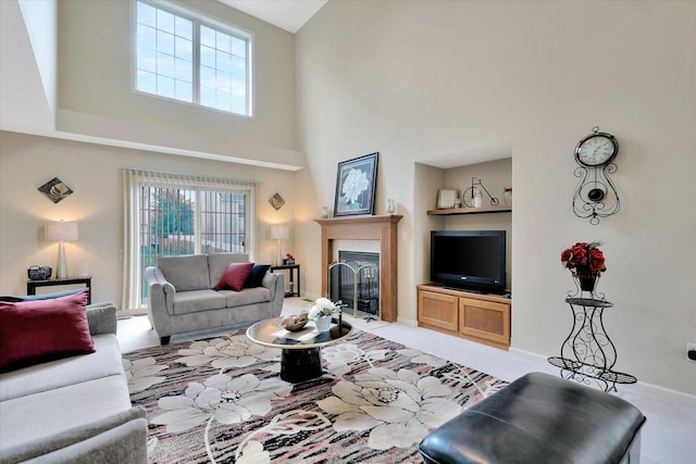 3911 Summer Sage Ct, Champaign, IL 61822 - living room featuring plenty of natural light, a towering ceiling, and a glass covered fireplace