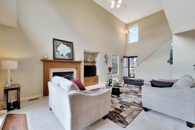 3911 Summer Sage Ct, Champaign, IL 61822 - living area featuring ceiling fan, a high ceiling, a fireplace, and light colored carpet