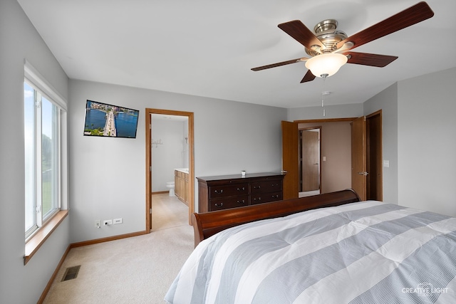 25411 W Juniper Ct, Plainfield, IL 60585 - bedroom with multiple windows, light carpet, a ceiling fan, and ensuite bathroom