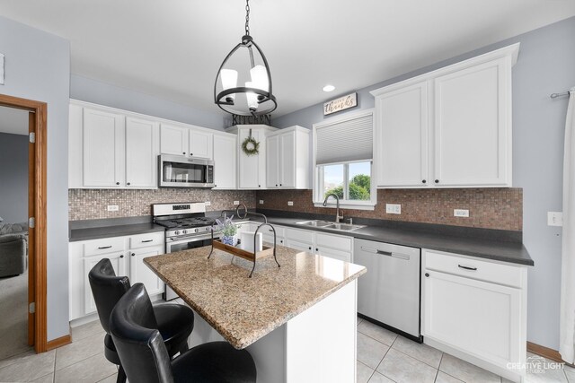 25411 W Juniper Ct, Plainfield, IL 60585 - kitchen with stainless steel appliances, light tile patterned floors, white cabinets, backsplash, and recessed lighting