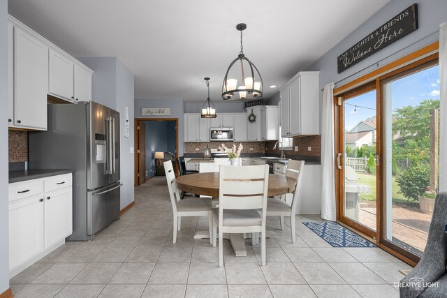 25411 W Juniper Ct, Plainfield, IL 60585 - dining area with a chandelier and light tile patterned floors