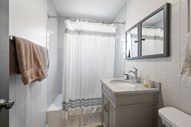 318 Custer Ave, Evanston, IL 60202 - bathroom featuring tile walls, vanity, toilet, and shower / bath combination with curtain
