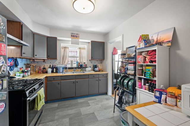 318 Custer Ave, Evanston, IL 60202 - kitchen featuring gray cabinetry, gas stove, a sink, decorative backsplash, and light countertops