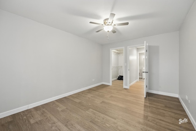 5500 Carriageway Dr Unit 213, Rolling Meadows, IL 60008 - unfurnished bedroom with baseboards, light wood-style flooring, a walk in closet, and a closet