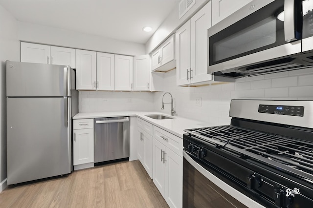 5500 Carriageway Dr Unit 213, Rolling Meadows, IL 60008 - kitchen featuring stainless steel appliances, a sink, white cabinetry, light countertops, and recessed lighting