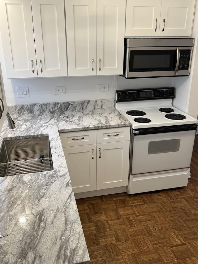 7 Garden Dr Unit 7, La Grange Park, IL 60526 - kitchen featuring white electric stove, stainless steel microwave, white cabinetry, and light stone counters