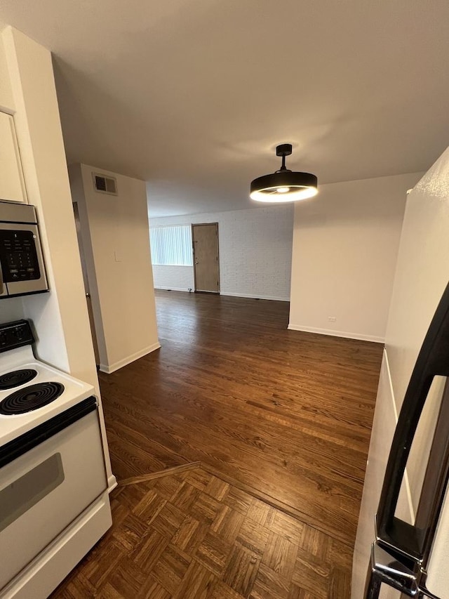 7 Garden Dr Unit 7, La Grange Park, IL 60526 - kitchen featuring electric range, stainless steel microwave, baseboards, dark wood-type flooring, and light countertops