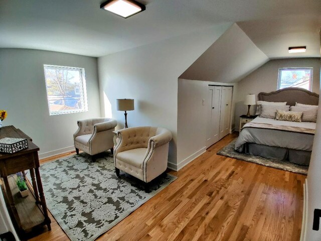 7726 N Harlem Ave, Niles, IL 60714 - bedroom featuring wood finished floors, vaulted ceiling, and baseboards