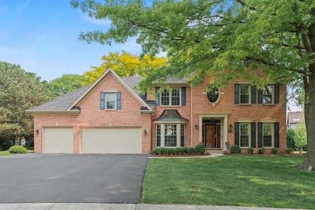 1514 Triple Crown Ct, Saint Charles, IL 60174 - view of front of home featuring asphalt driveway, a front yard, brick siding, a garage, and roof with shingles
