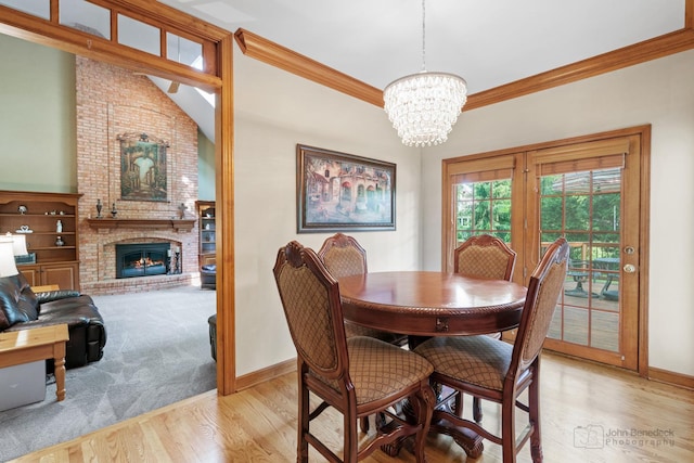 1514 Triple Crown Ct, Saint Charles, IL 60174 - dining area featuring a chandelier, wood finished floors, baseboards, a fireplace, and crown molding