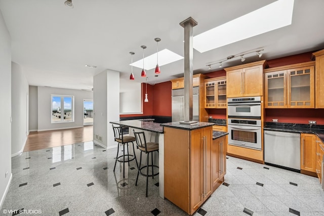 1 Renaissance Pl Unit 4Ph, Palatine, IL 60067 - kitchen featuring stainless steel appliances, granite tiled floors, a kitchen island, glass insert cabinets, and a breakfast bar