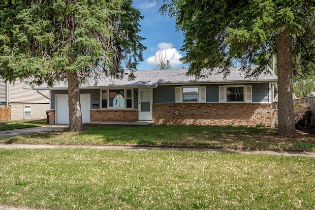 1216 Ramona Ter, Machesney Park, IL 61115 - view of front of home with brick siding, driveway, an attached garage, and a front yard