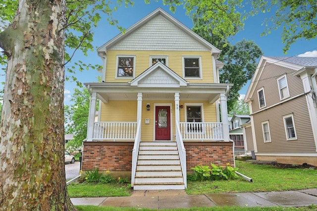 93 Liberty St, West Dundee, IL 60118 - american foursquare style home with a porch, brick siding, and a front lawn