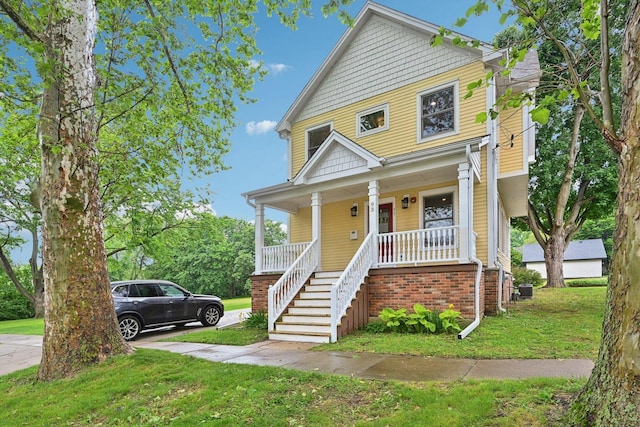93 Liberty St, West Dundee, IL 60118 - traditional style home with a porch, a front lawn, stairway, and central AC unit