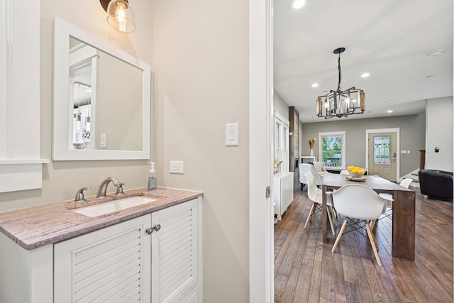 93 Liberty St, West Dundee, IL 60118 - kitchen with a sink, recessed lighting, a chandelier, wood-type flooring, and white cabinetry