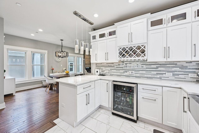 93 Liberty St, West Dundee, IL 60118 - kitchen featuring beverage cooler, a peninsula, white cabinets, recessed lighting, and tasteful backsplash