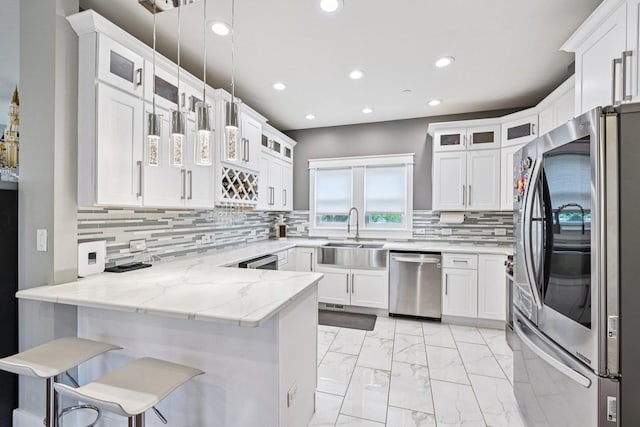 93 Liberty St, West Dundee, IL 60118 - kitchen with appliances with stainless steel finishes, a sink, a peninsula, light marble finish floors, and white cabinets