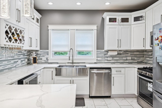 93 Liberty St, West Dundee, IL 60118 - kitchen with stainless steel appliances, a sink, light marble finish floors, white cabinetry, and recessed lighting