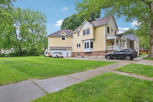 93 Liberty St, West Dundee, IL 60118 - view of front of home with an attached garage, driveway, a front lawn, and brick siding