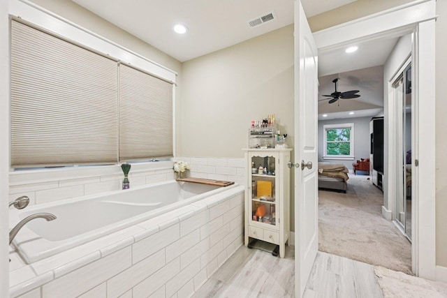 93 Liberty St, West Dundee, IL 60118 - bathroom with a garden tub, connected bathroom, a ceiling fan, recessed lighting, and wood finished floors