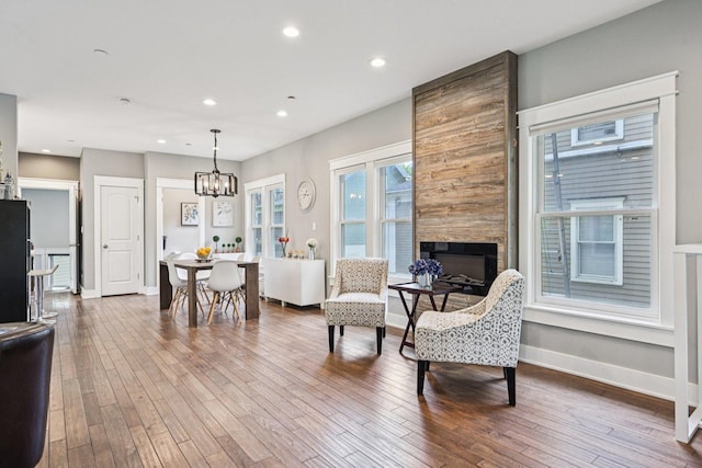93 Liberty St, West Dundee, IL 60118 - living area featuring a chandelier, a fireplace, hardwood / wood-style floors, recessed lighting, and baseboards