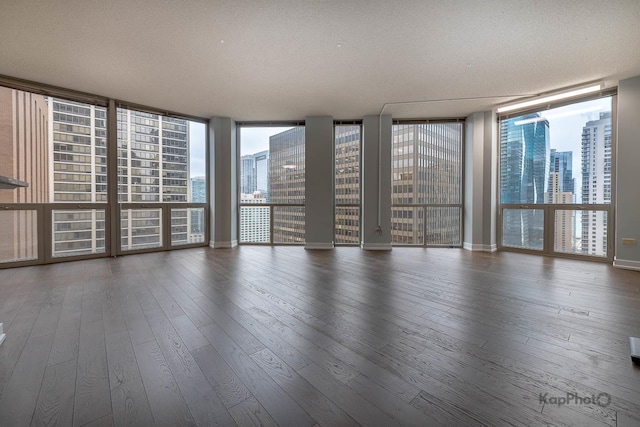 222 N Columbus Dr Unit 2808, Chicago, IL 60601 - unfurnished room with a view of city, hardwood / wood-style flooring, a textured ceiling, floor to ceiling windows, and baseboards