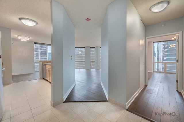 222 N Columbus Dr Unit 2808, Chicago, IL 60601 - hall with a textured ceiling, baseboards, and light wood-style flooring