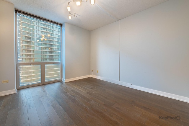 222 N Columbus Dr Unit 2808, Chicago, IL 60601 - empty room with dark wood-style floors, baseboards, and a textured ceiling