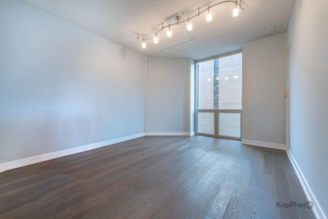 222 N Columbus Dr Unit 2808, Chicago, IL 60601 - empty room with floor to ceiling windows, a textured ceiling, dark wood-style flooring, and baseboards