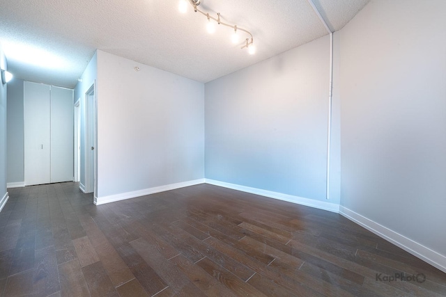 222 N Columbus Dr Unit 2808, Chicago, IL 60601 - empty room with dark wood-type flooring, a textured ceiling, and baseboards