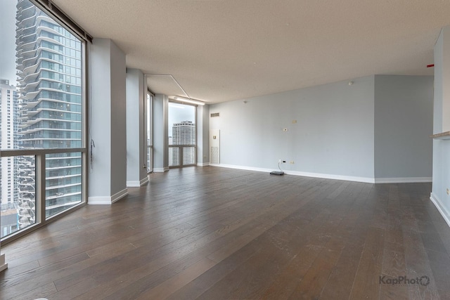 222 N Columbus Dr Unit 2808, Chicago, IL 60601 - unfurnished living room featuring hardwood / wood-style flooring, baseboards, a wall of windows, and a textured ceiling